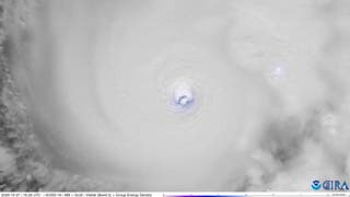 Lightning flashes in Melissa's eye of the storm